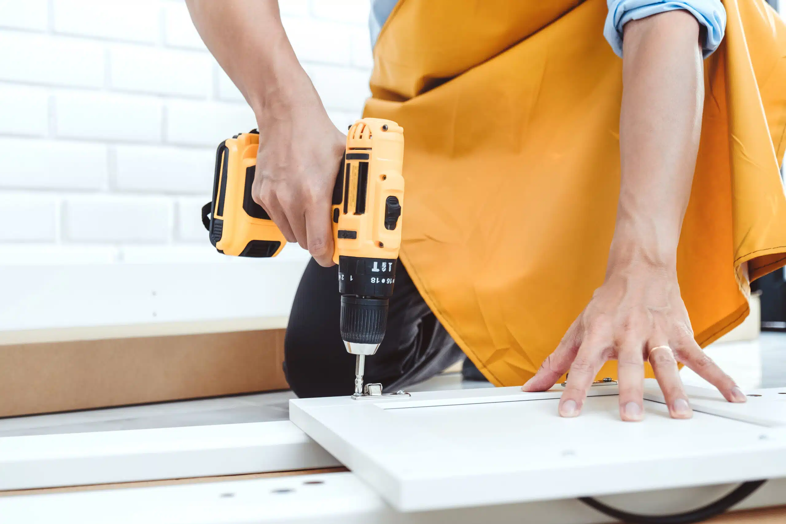 Happy asian man home improvement Assembling Furniture Reads Inst